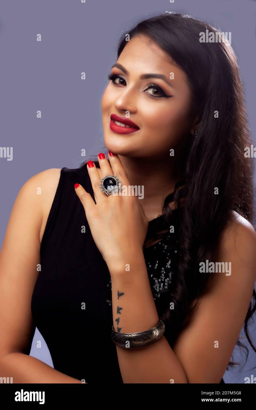 Portrait of beautiful indian girl in black colour fashion posses on dark background Stock Photo