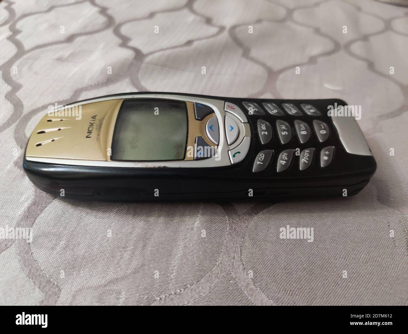 Nokia old Mobile Phone in black and gold colors, Nokia's most popular phone launched in the 2000's Stock Photo