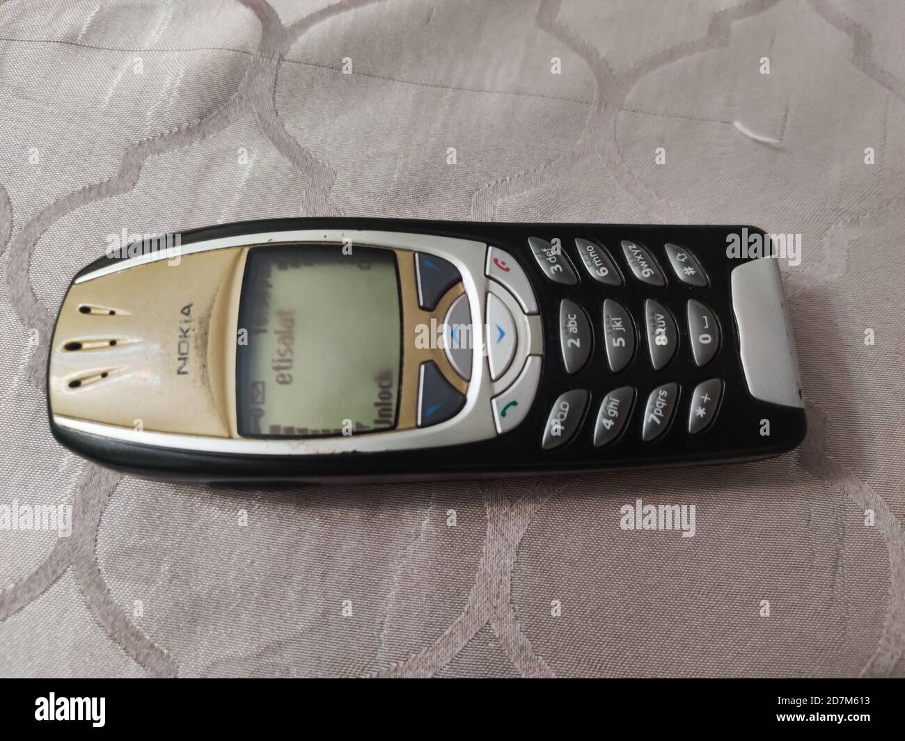 Nokia old Mobile Phone in black and gold colors, Nokia's most popular phone launched in the 2000's Stock Photo