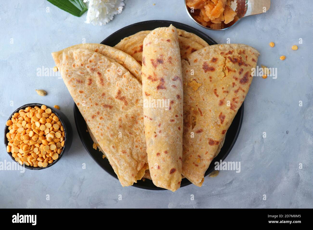 Holi Festival Food - Puran Poli is an Indian sweet flatbread stuffed with a mixture of chana dal, jaggery, ghee & cardamom. Usually eaten on Holi or Gud Stock Photo