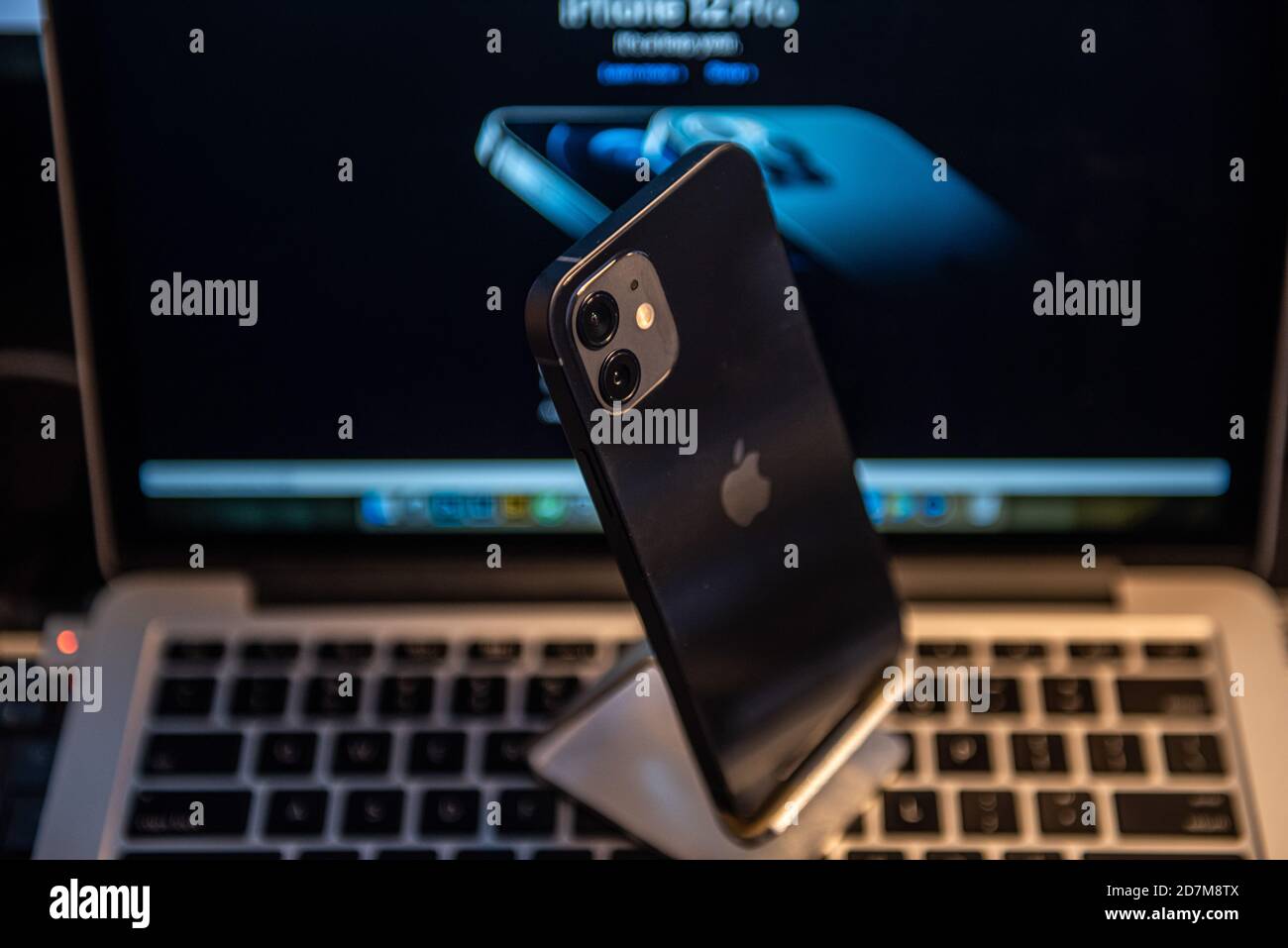 China. 23rd Oct, 2020. In this photo illustration an iPhone 12 smartphone is placed on a keyboard of a MacBook Pro laptop.Dual camera design on the rear side can be seen. iPhone 12 series was released on Oct 13th and began shipping on Oct 23rd. Credit: SOPA Images Limited/Alamy Live News Stock Photo