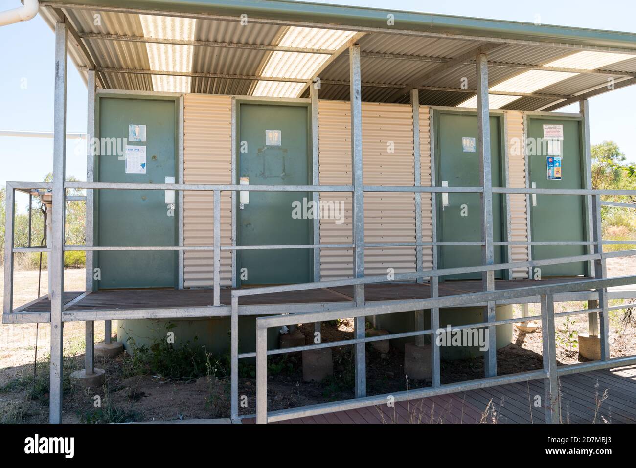 Toilets at rest stop in outback Queensland uses rainwater and septic system with steel posts and iron sheeting in White Mountains National Park Stock Photo