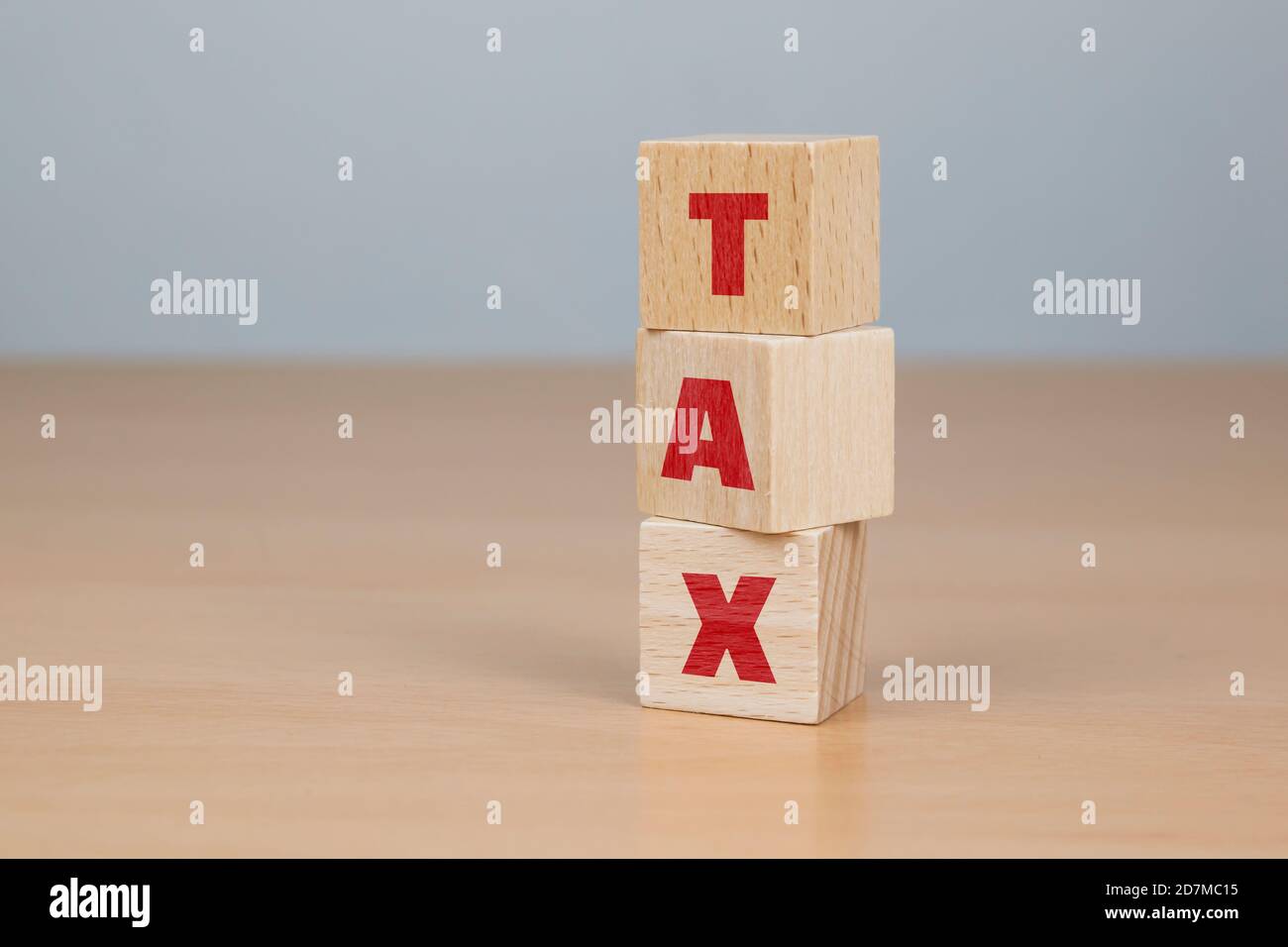 Businessman made word TAX with wood building blocks Stock Photo Alamy