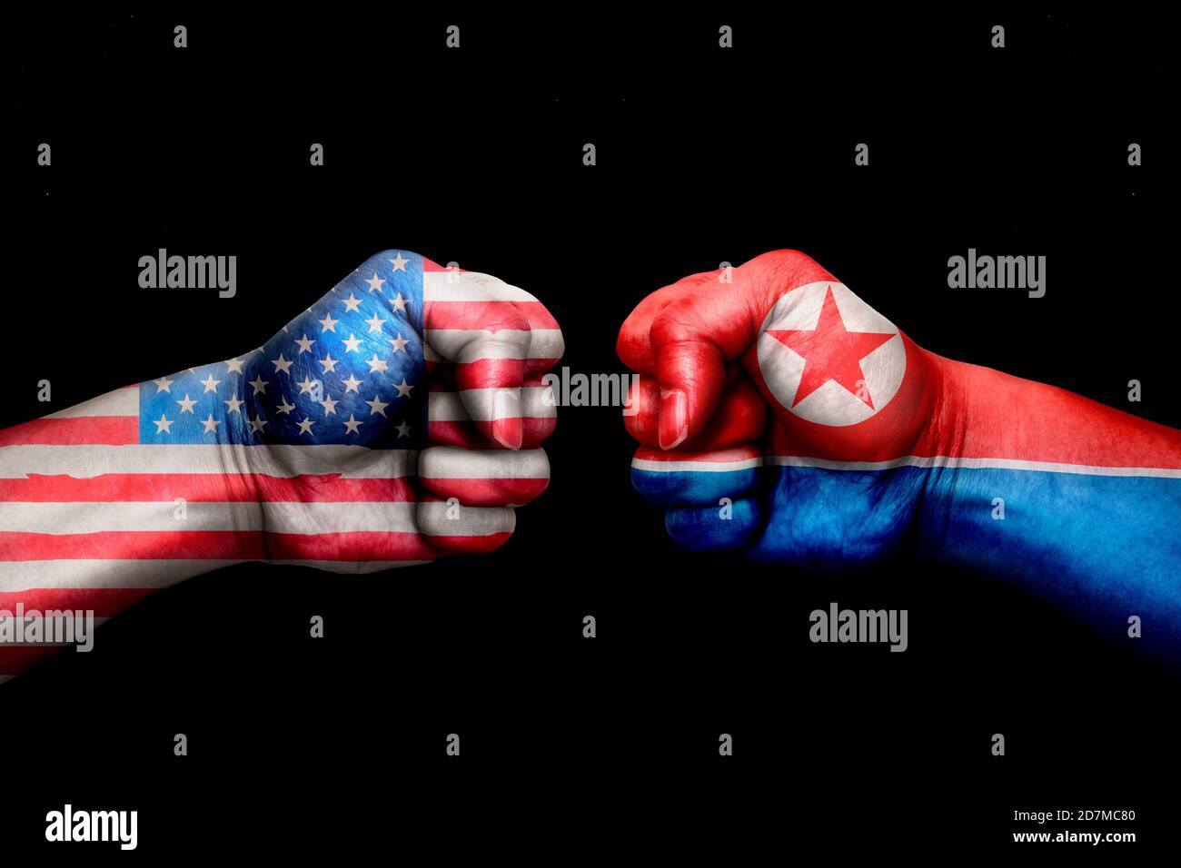 conflict between USA vs Korea north, male fists - governments conflict concept, Flags written on hands USA, USA Flag, USA counter, fists symbol war Stock Photo