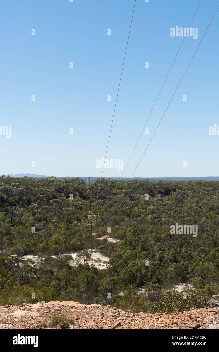 Power lines supplying power to the Queensland outback going through White Mountains National Park and Sawpit Gorge Stock Photo