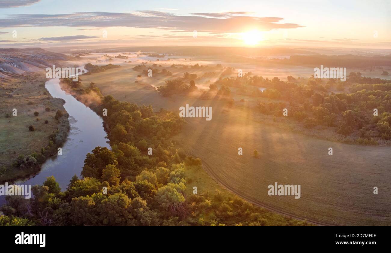 sunrise aerial drone landscape of river in green field, top view of ...