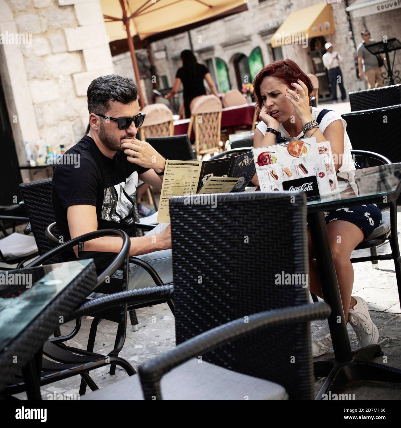 Kotor, Montenegro, Sep 18, 2019: Seated couple in a street café Stock Photo