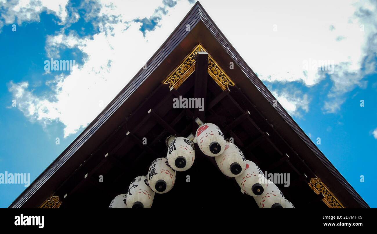 Japanese temple shrine shinto corner with lanterns hanging and gold details on a wooden structure in kyoto japan luxury travel adventure clouds Stock Photo