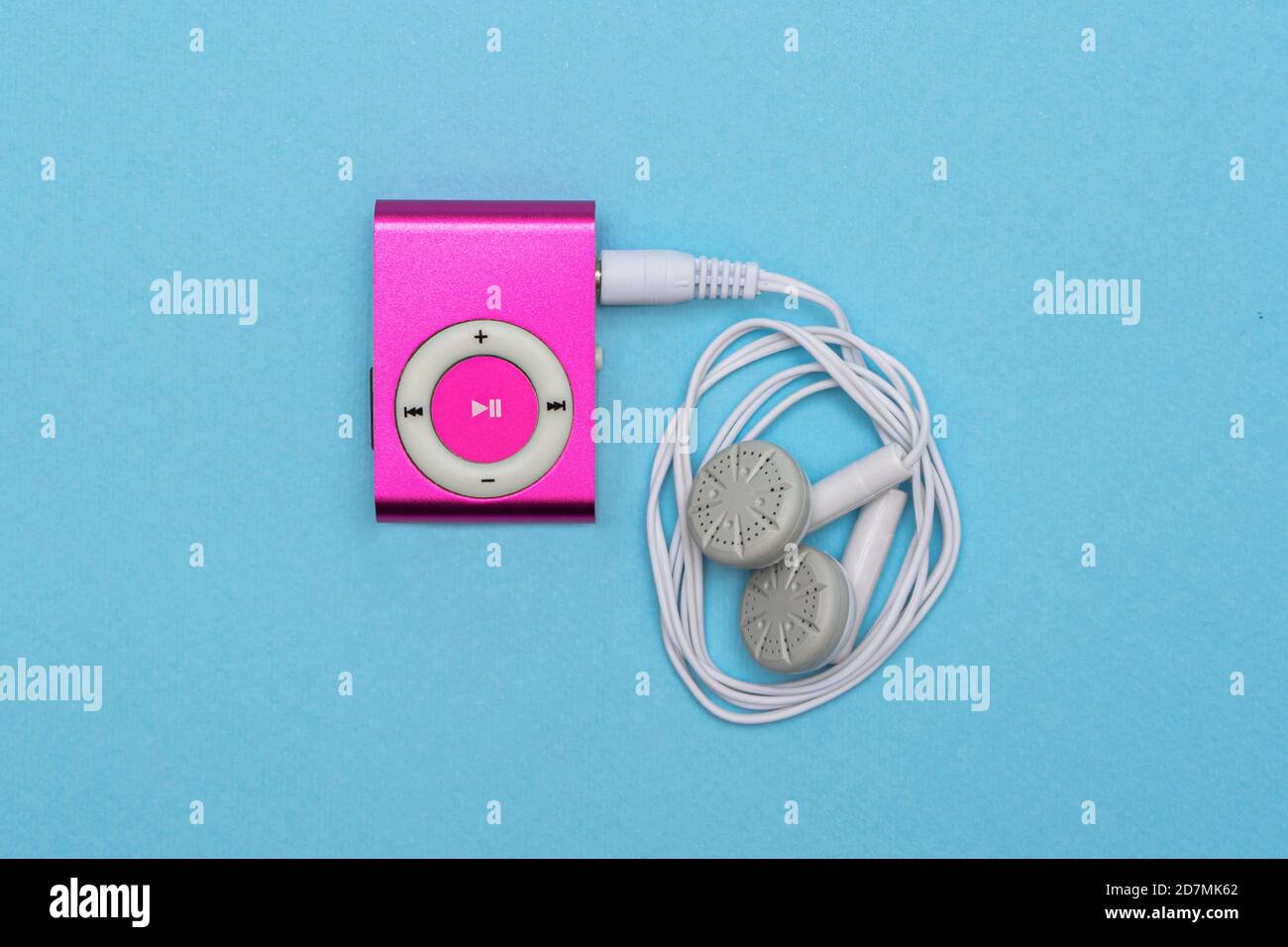 Digital Pink MP3 Player with Headphone on blue background Stock Photo