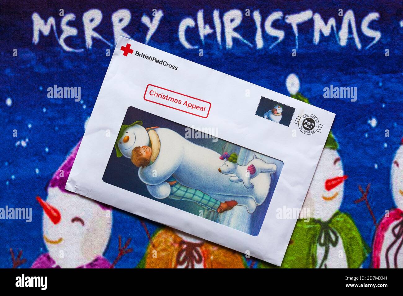 Post on Christmas mat - charity appeal, Christmas appeal from British Red Cross - Merry Christmas Stock Photo