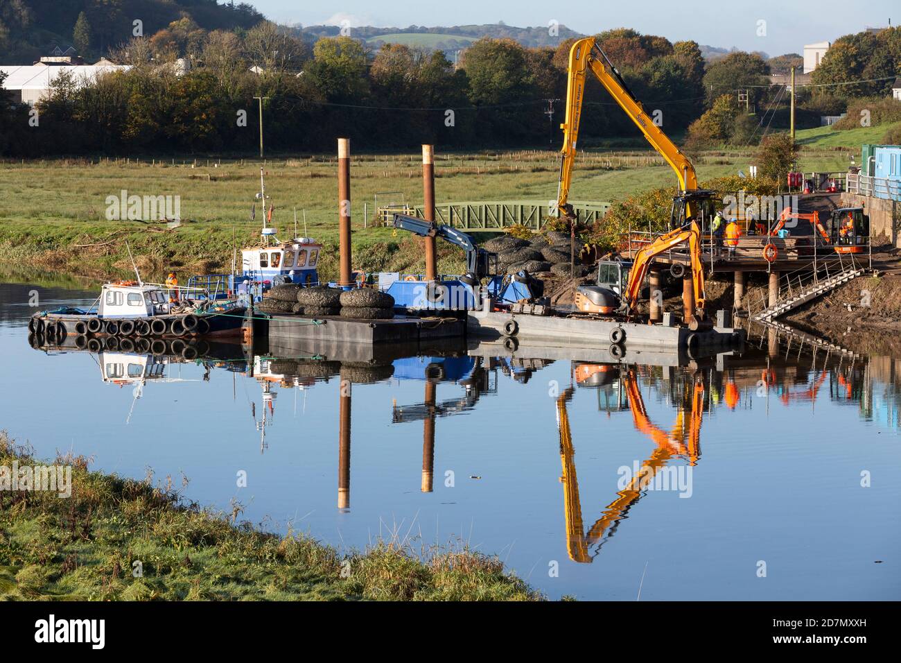 Plant, machinery, boats, barges and workmen on the Towy River in