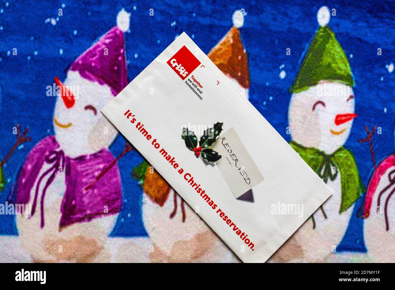 Post on Christmas mat - charity appeal, Crisis together we will end homelessness - it's time to make a Christmas reservation Stock Photo
