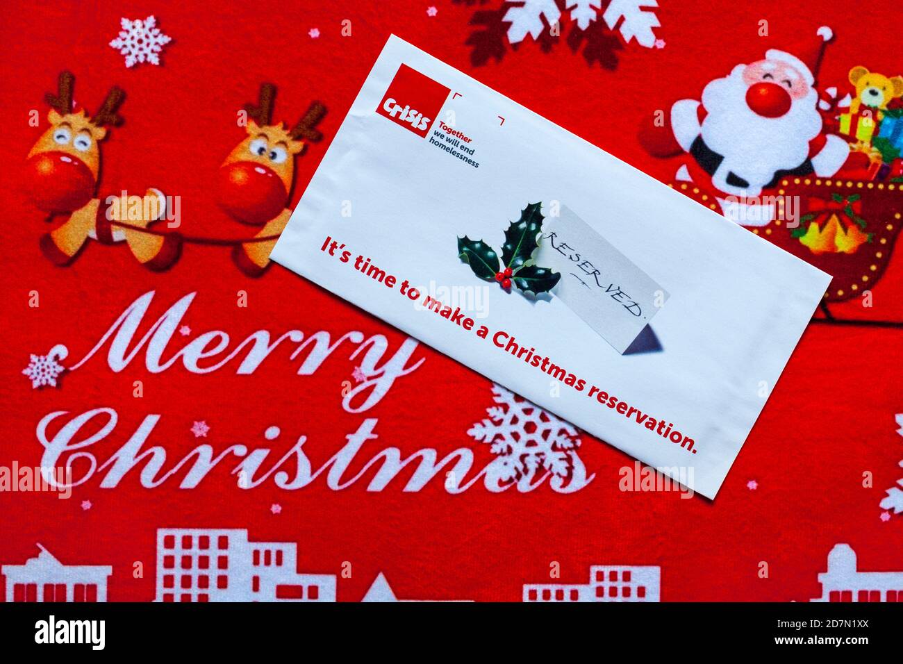 Post on Christmas mat - charity appeal, Crisis together we will end homelessness - it's time to make a Christmas reservation - Merry Christmas Stock Photo