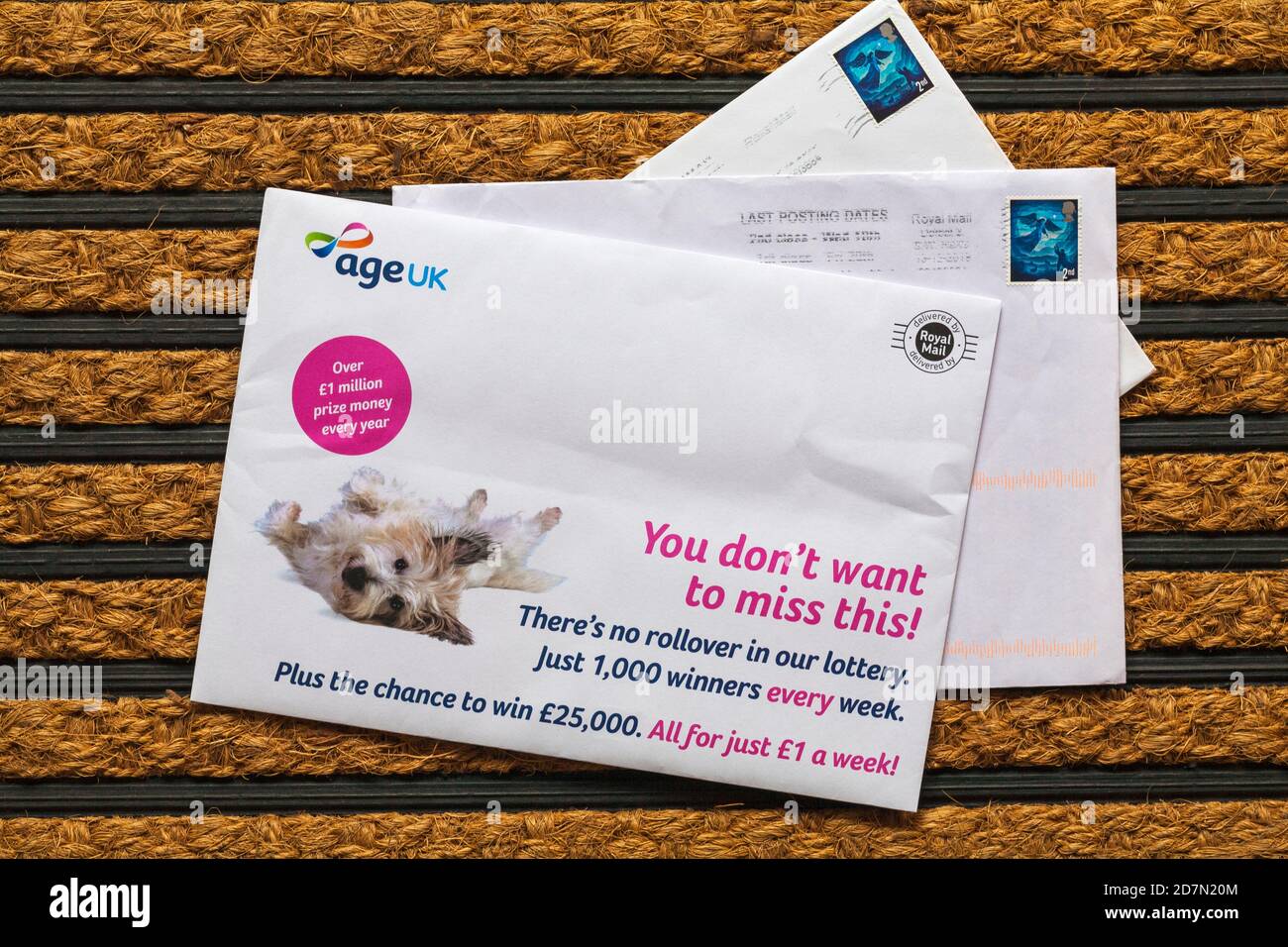 Post mail on doormat - Age UK weekly lottery Stock Photo