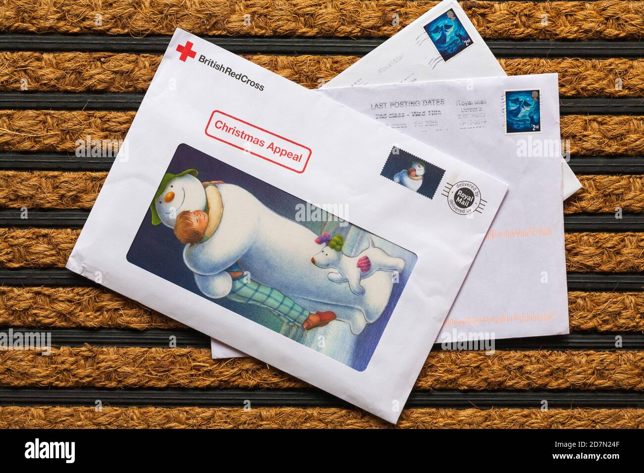 Post mail on doormat - charity appeal, Christmas appeal from British Red Cross Stock Photo
