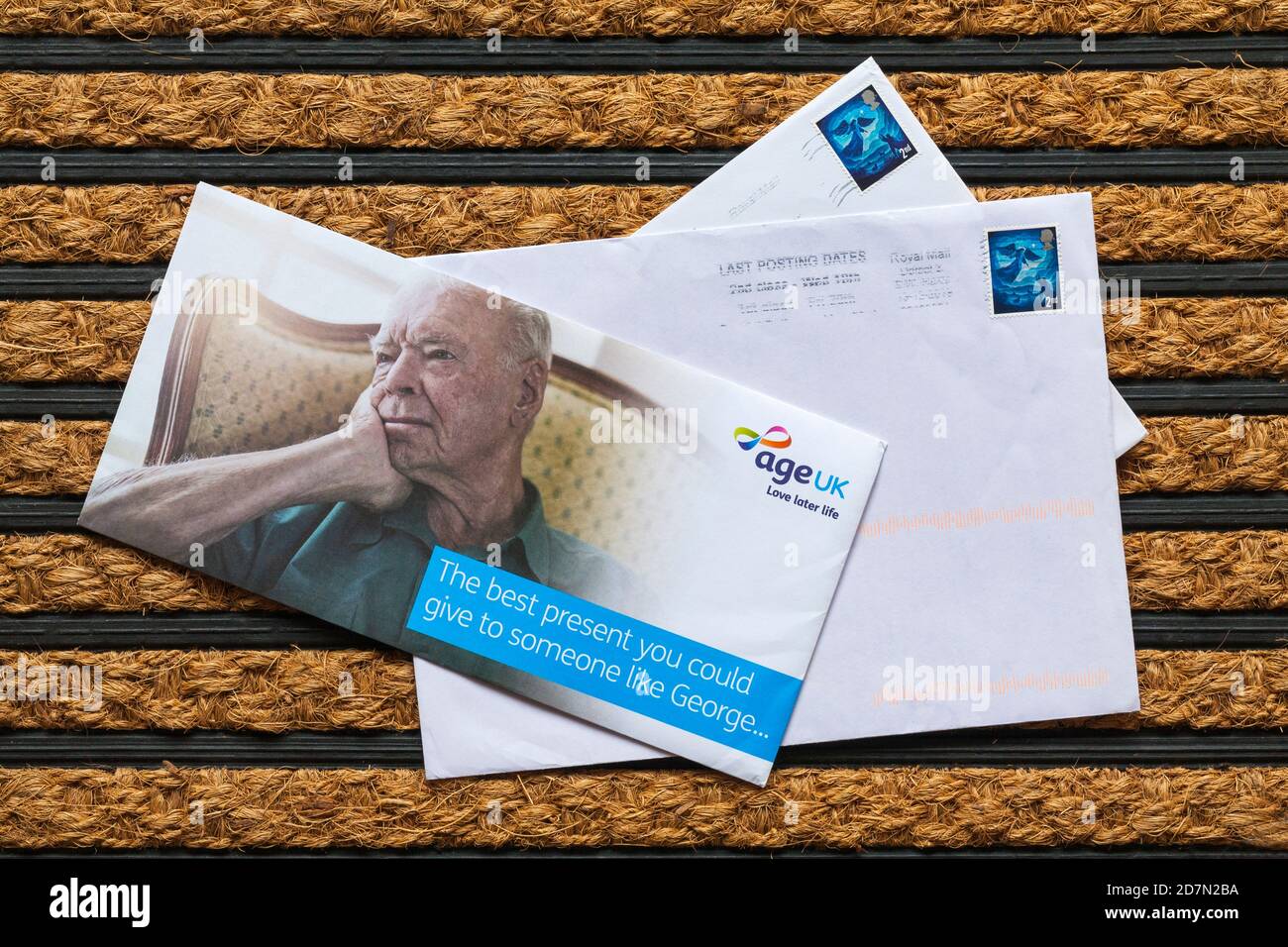 Post mail on doormat including letter from age UK love later life - the best present you could give to someone like George Stock Photo