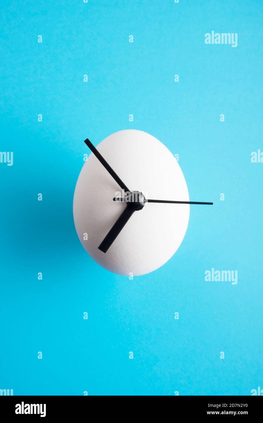 Egg-clock on a vivid colorful background. Stock Photo