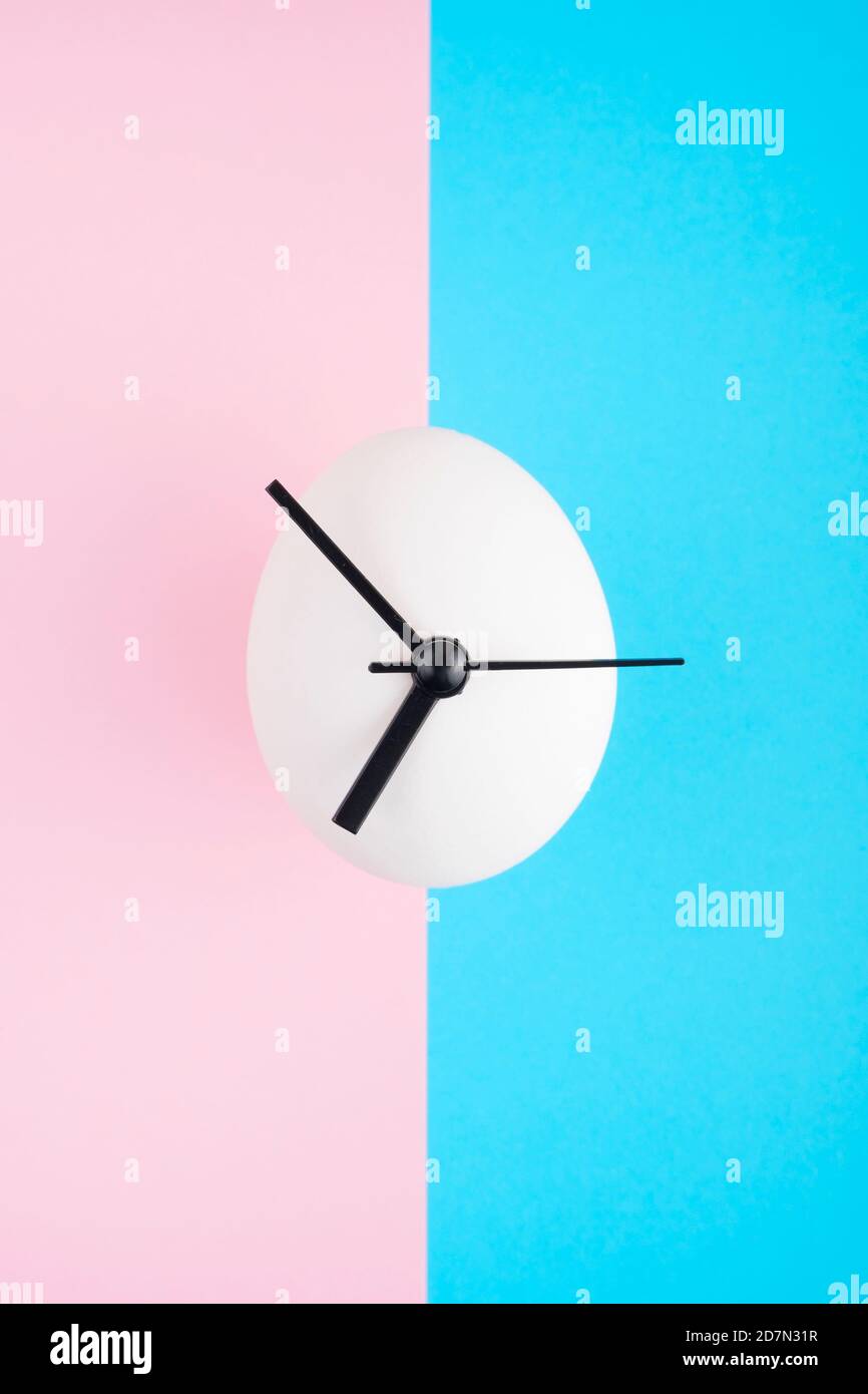 Egg-clock on a vivid colorful background. Stock Photo