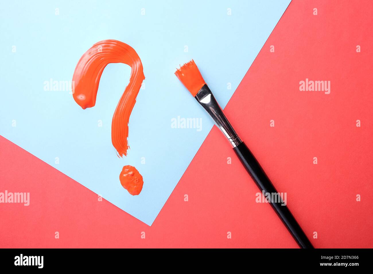 Red question mark painted on blue background. Stock Photo