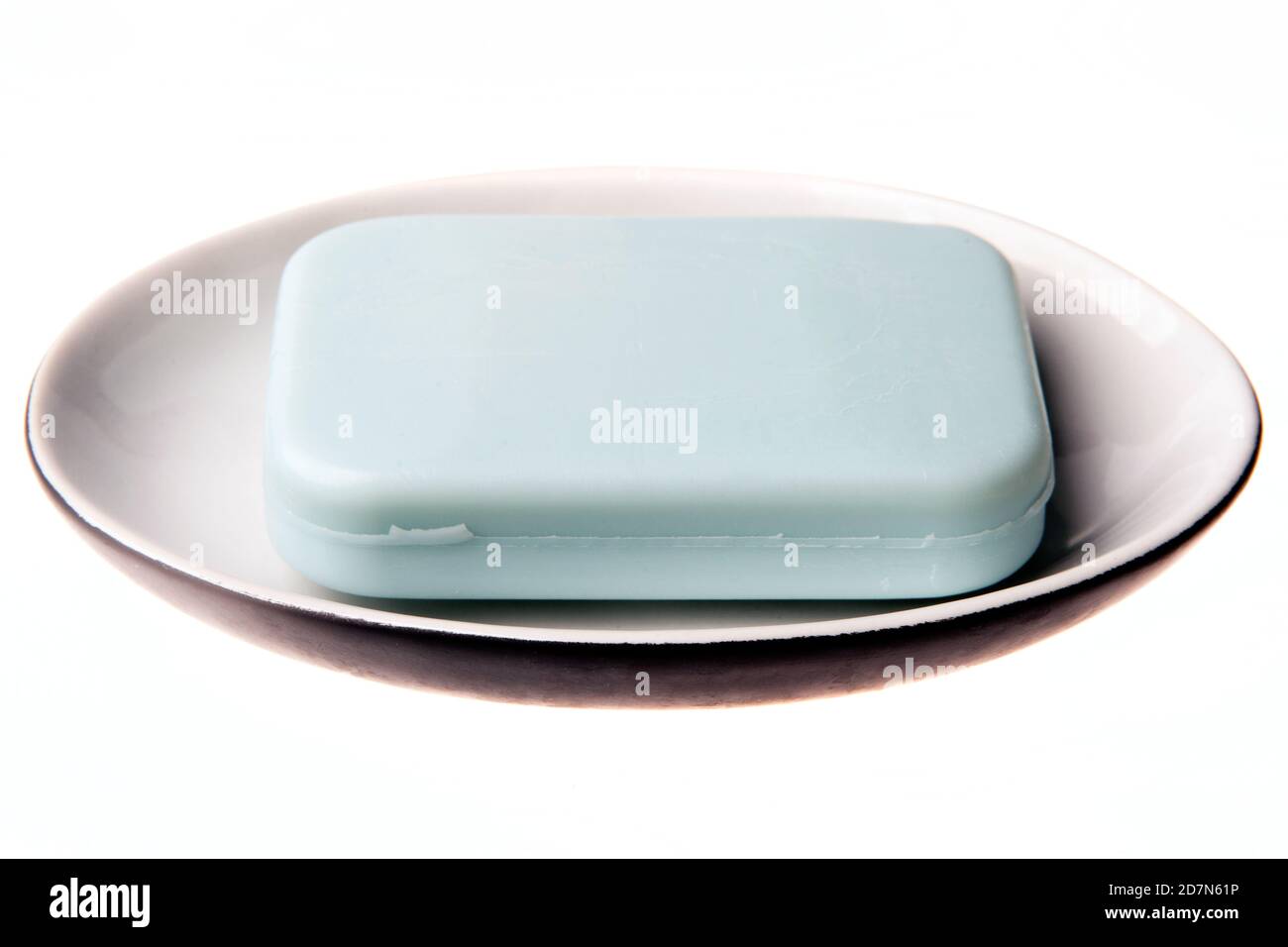 A bar of natural blue soap in a soap plate isolated on white background