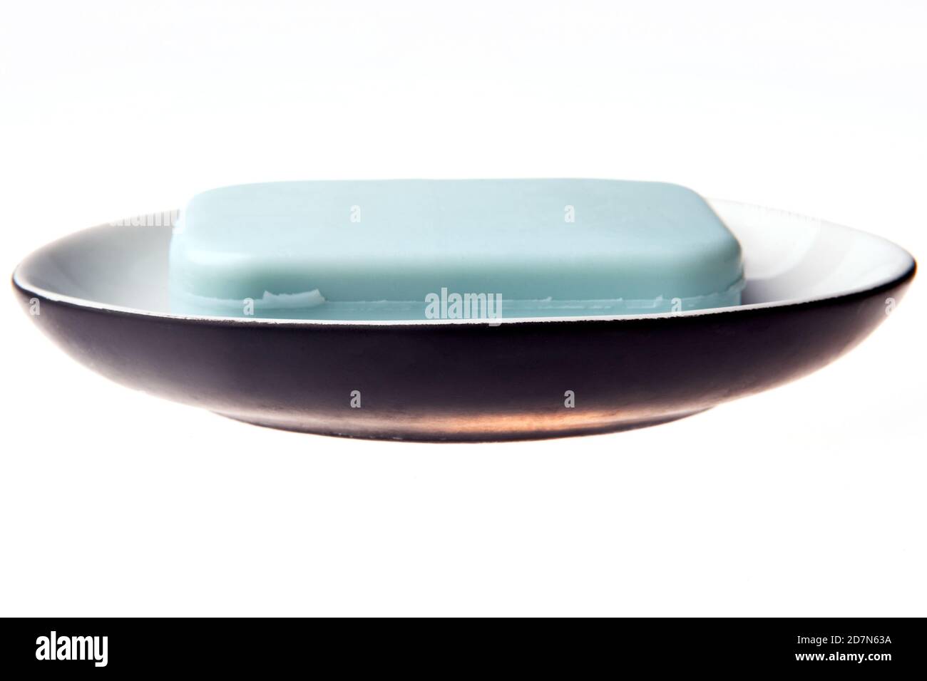 A bar of natural blue soap in a soap plate isolated on white background