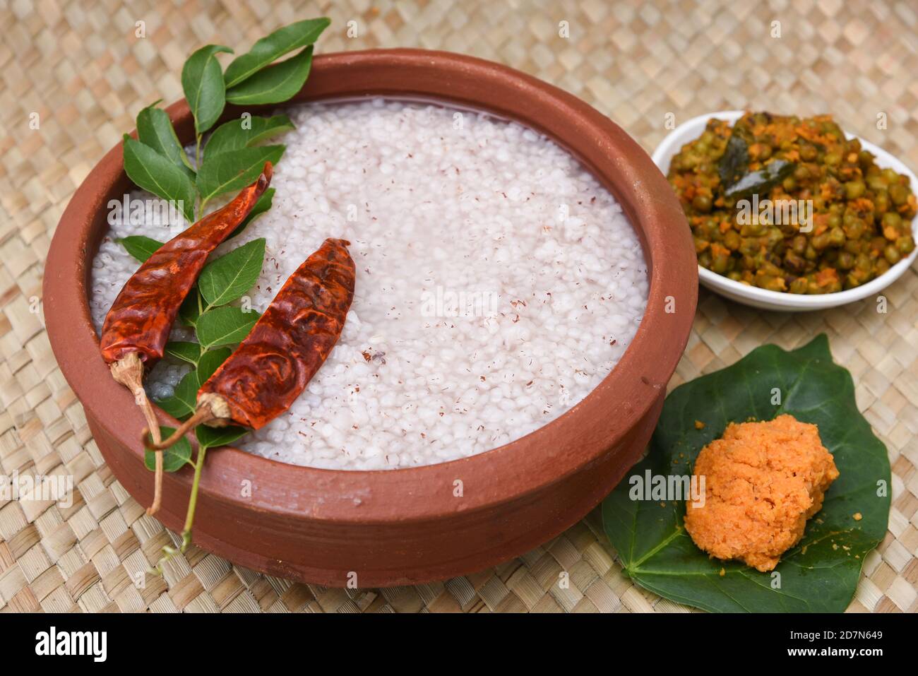 Rice porridge, Kanji, gruel in clay pot palm mat background Kerala