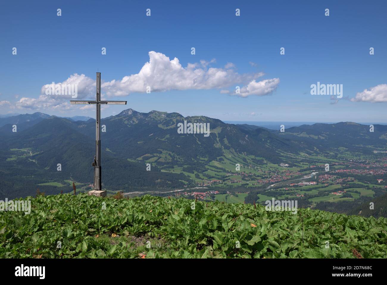 Cross at the summit plateau of Schoenberg and view of surrounding montains and villages, Bavaria, Germany Stock Photo