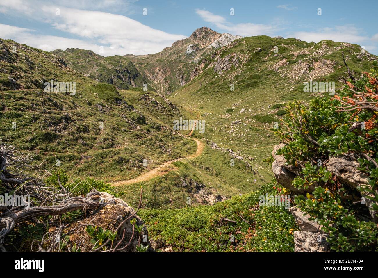 Little footpath surrounded by mountains in Somiedo Natural Park Stock Photo