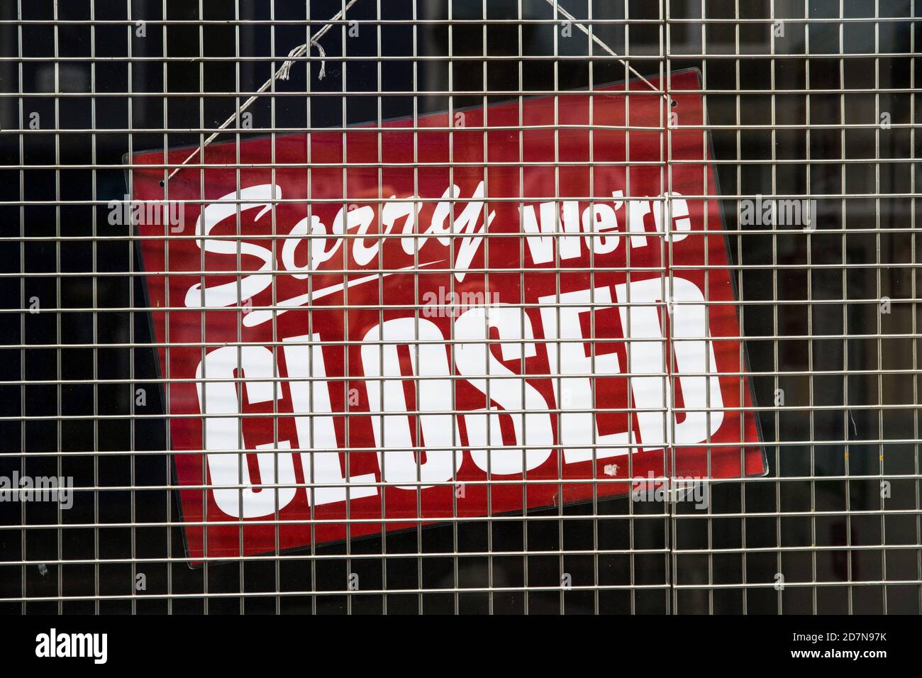 Sorry we're closed sign in the store window Stock Photo