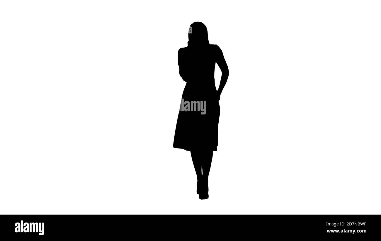 Silhouette Happy smiling woman talking on cell phone while walki Stock  Photo - Alamy