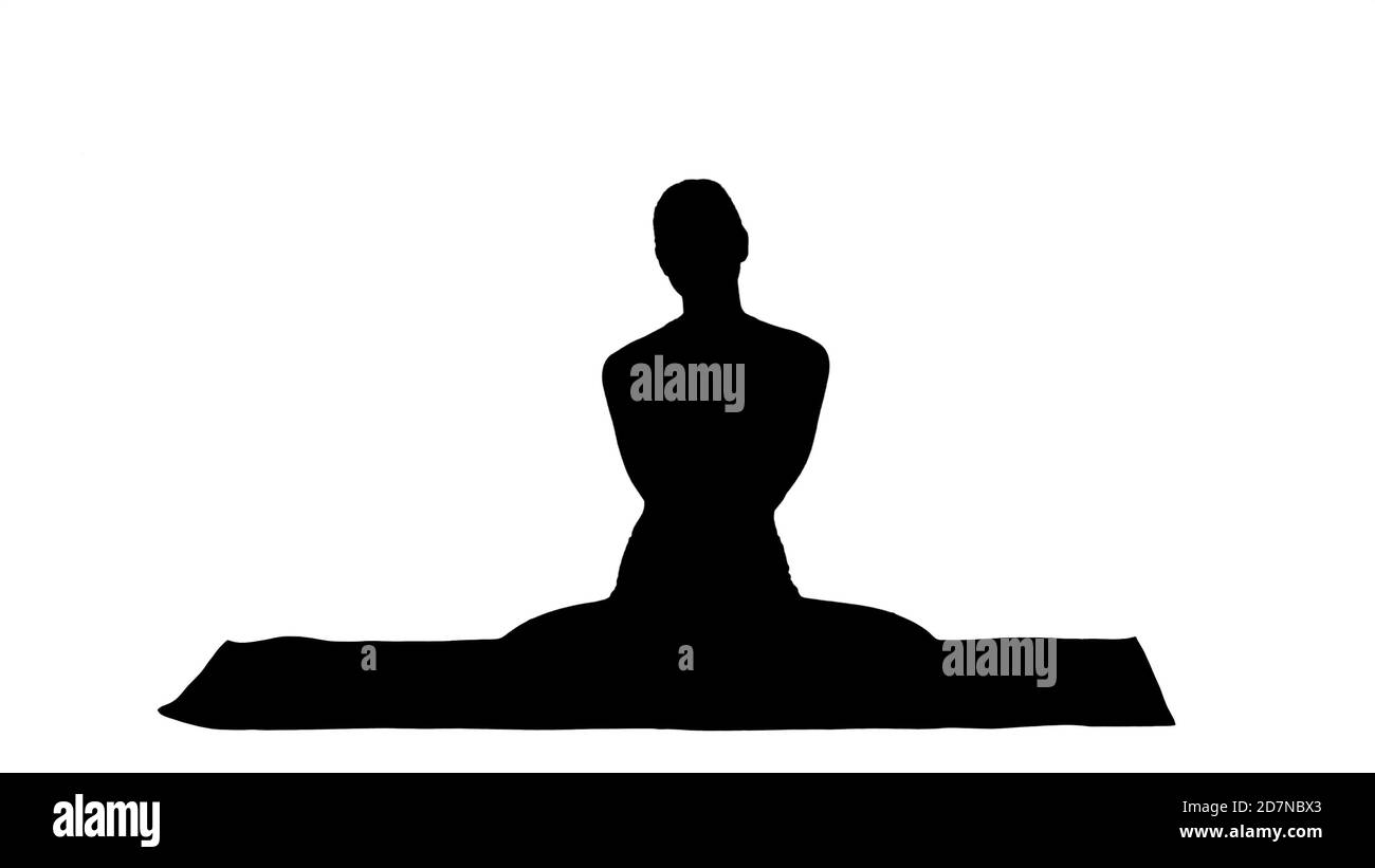 Silhouette Positive cheerful young female in yoga pose clapping Stock Photo