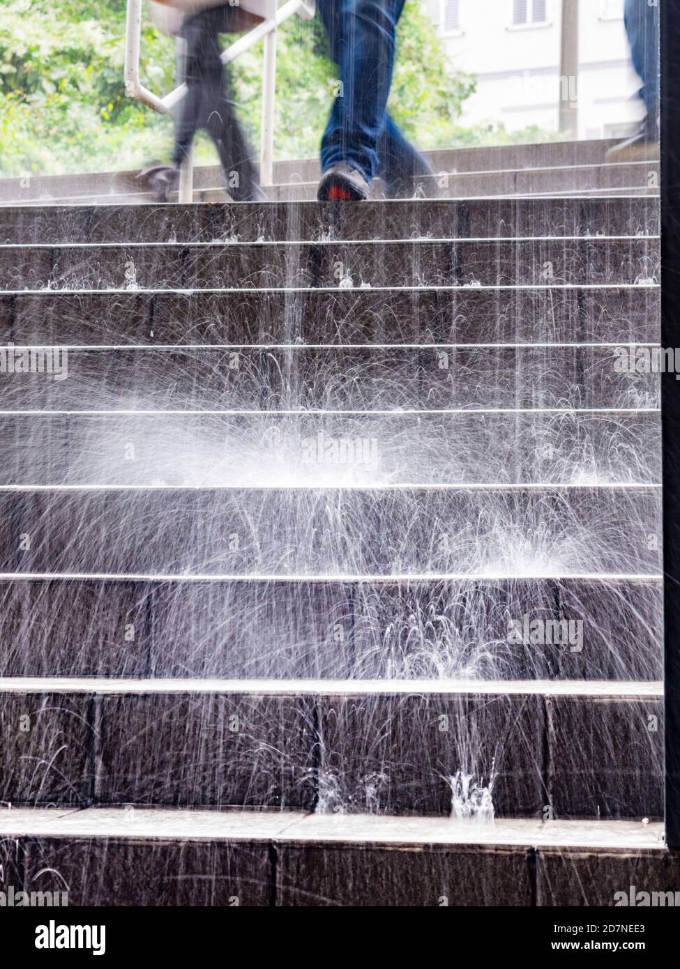 Rain falling pouring rain on stairs steps staircase people legs only  cropped crop view walking by blurry in background Stock Photo - Alamy