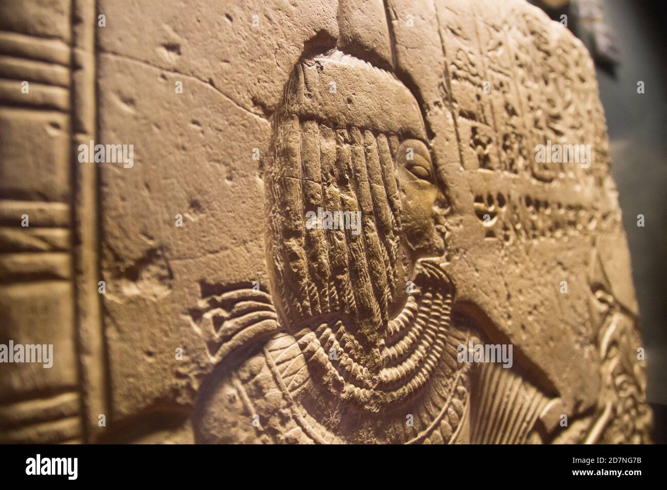ancient egypt wall with woman's face. The ancient Egyptian art of hieroglyphs carving on stone. Stock Photo
