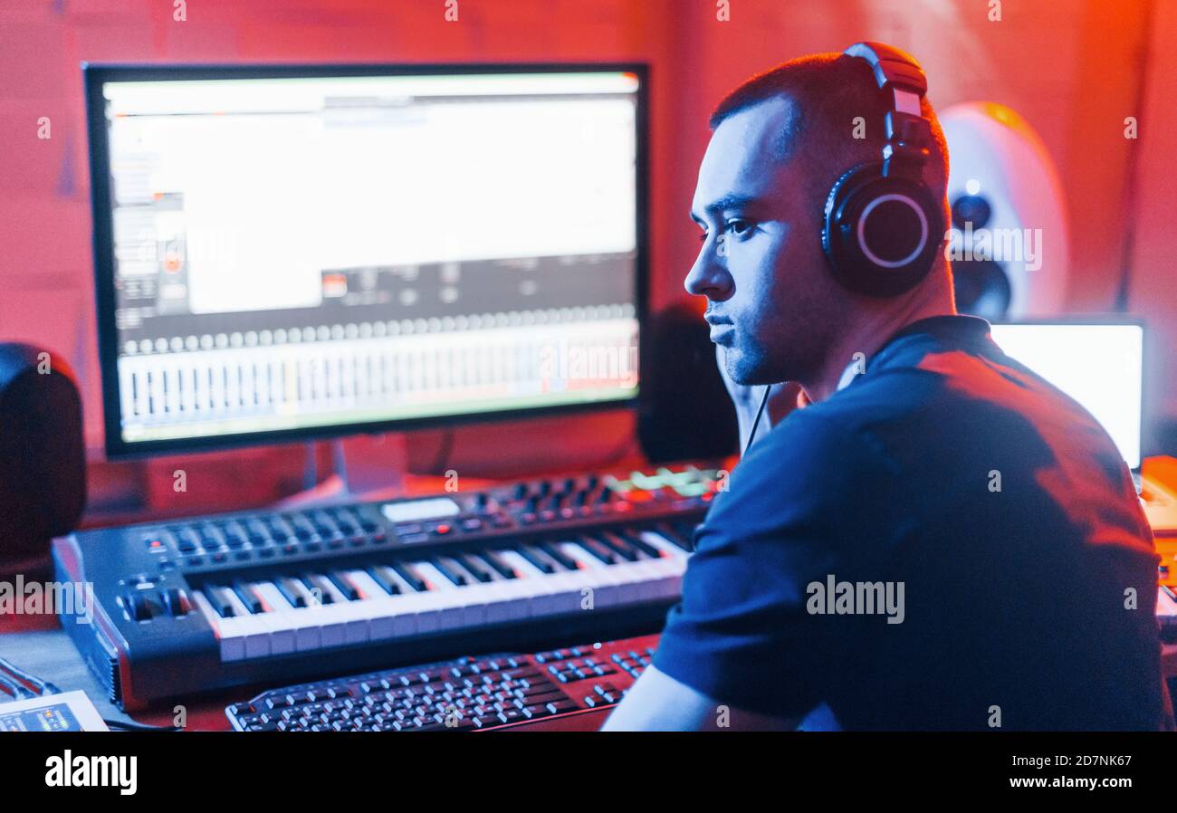 Sound engineer working and mixing music indoors in the studio near drum
