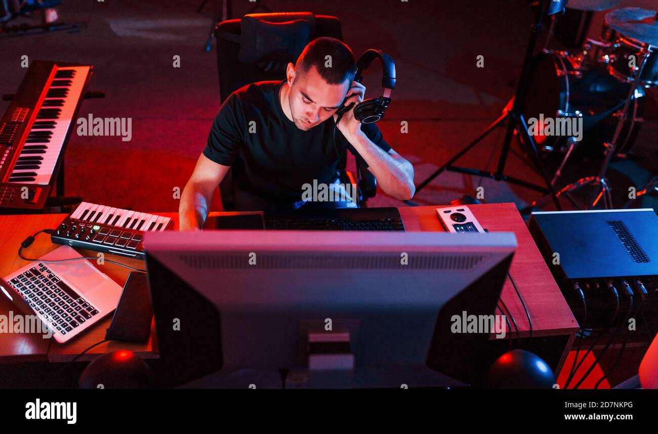Professional sound engineer working and mixing music indoors in the ...