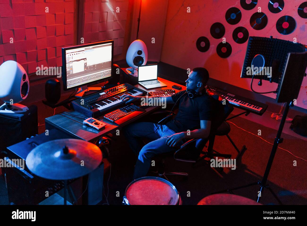 Sound engineer working and mixing music indoors in the studio near drum ...