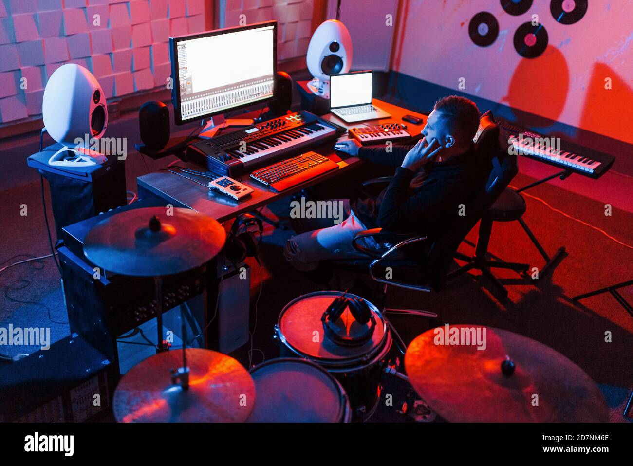 Sound engineer working and mixing music indoors in the studio near drum