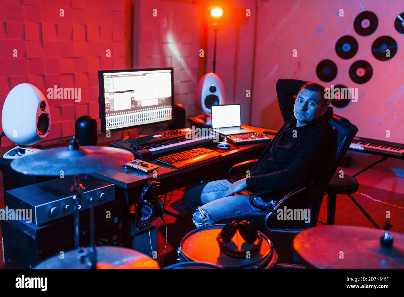 Sound engineer working and mixing music indoors in the studio near drum ...