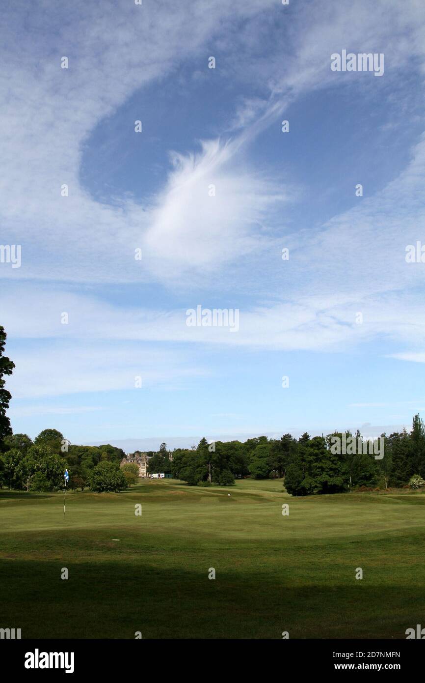 Ayr, South Ayrshire, Scotland, UK. A strange cloud formation over the golf course which makes it look like a hold has been punched in the cloud, known as Fallstreak or hole punch clouds. The clouds can form when water droplets are colder than freezing temperature but have yet to freeze. Stock Photo