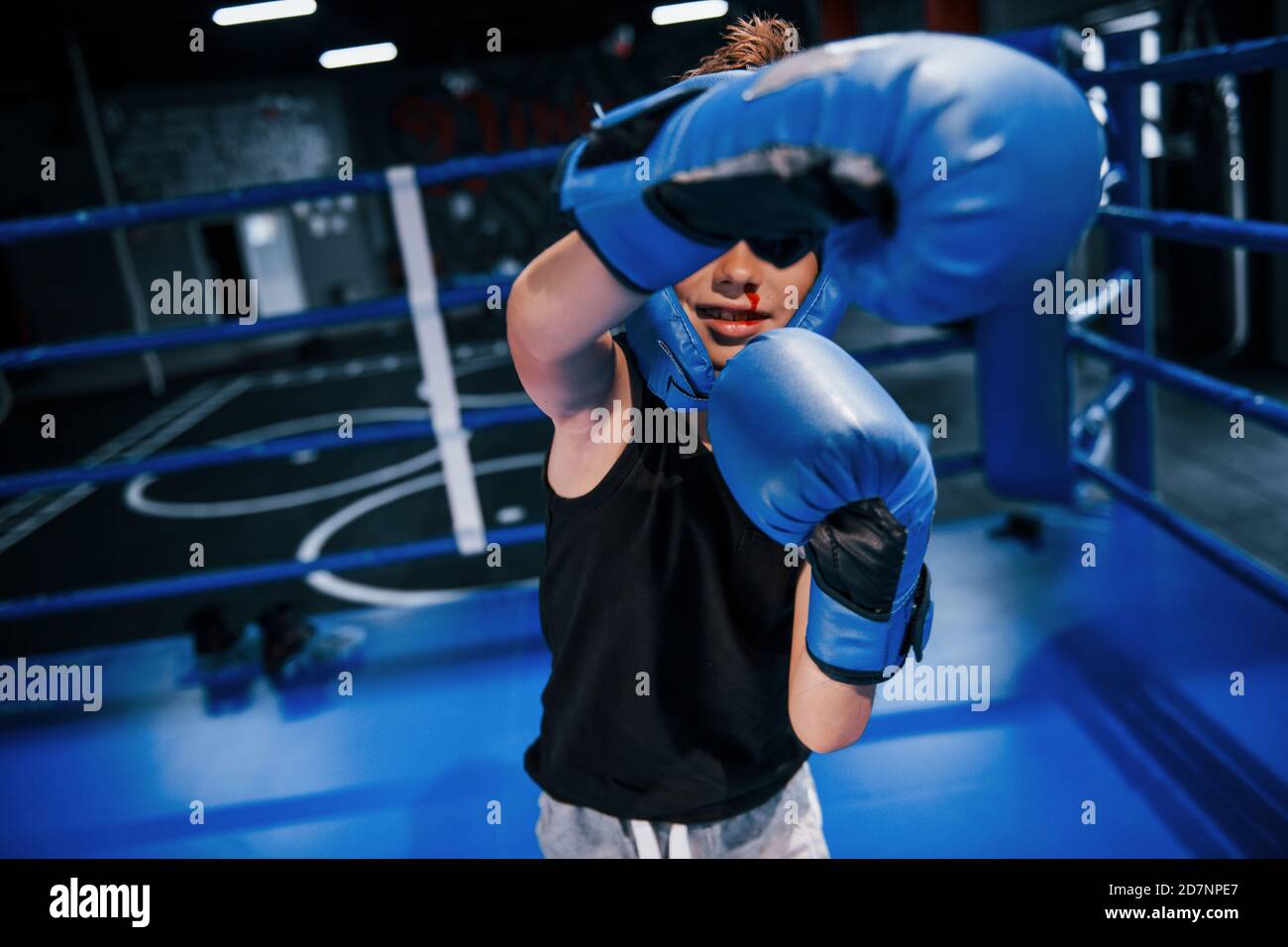 Little boy in protective wear and with nose bleed training in the