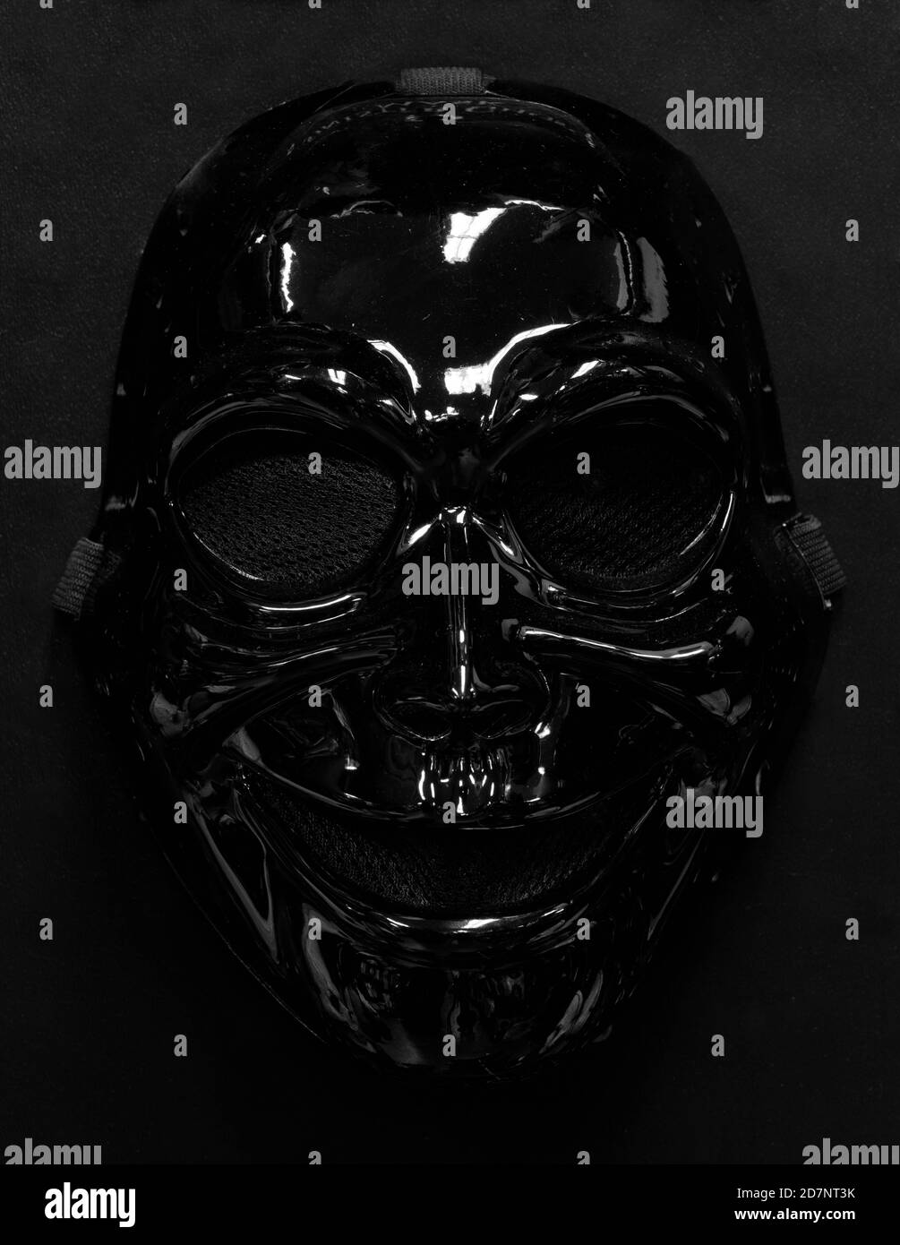 Black Sinister Ghost Mask Isolated Against Dark Background Stock Photo