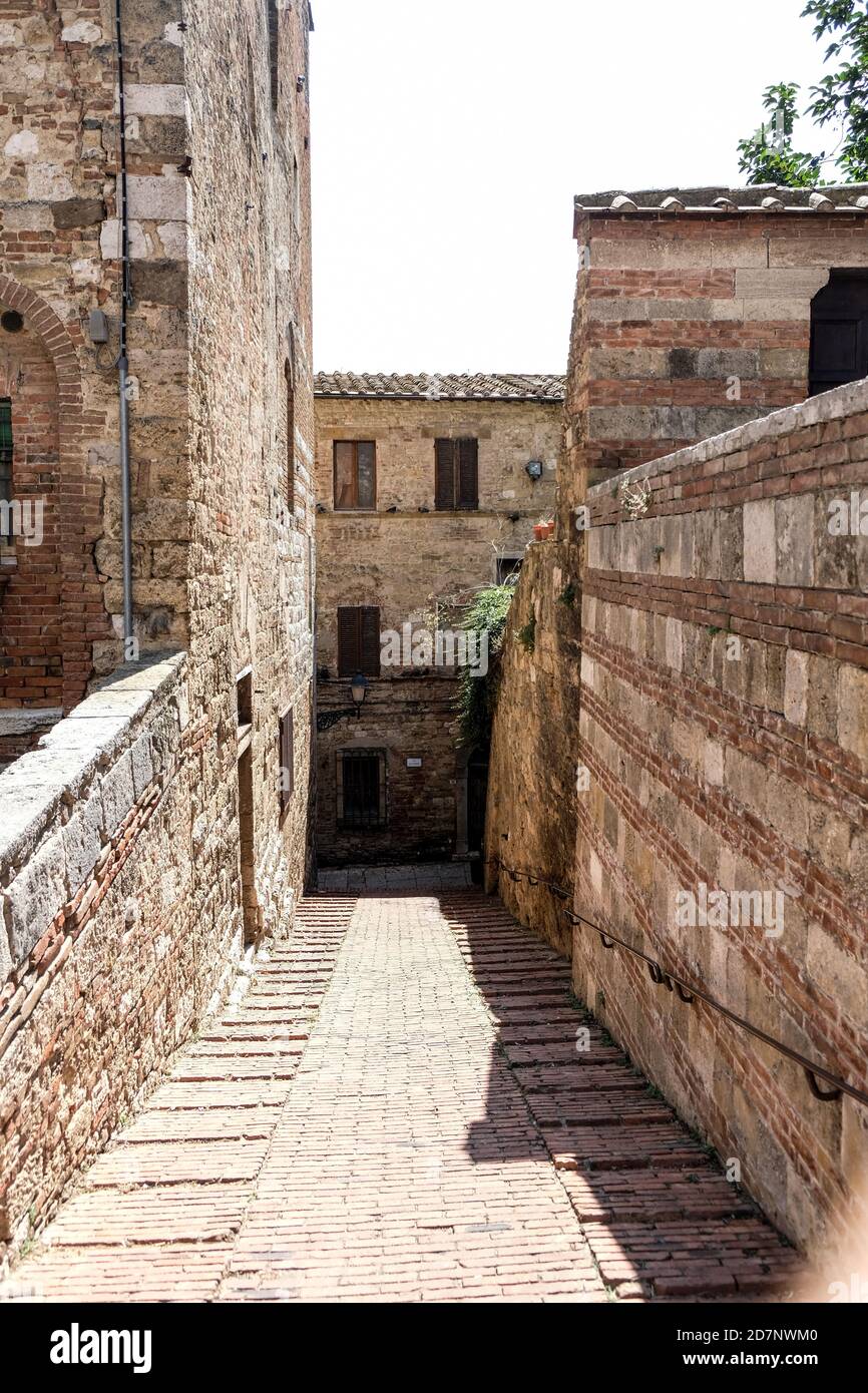 Authentic street in small village in tuscany in Italy with brown stones ...