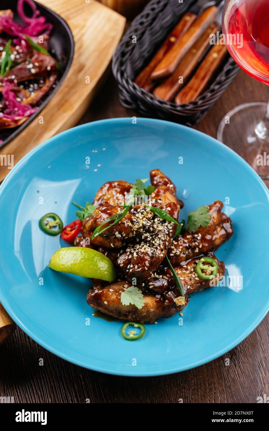 chicken wings in Chinese hot sauce with a slice of lime Stock Photo Alamy