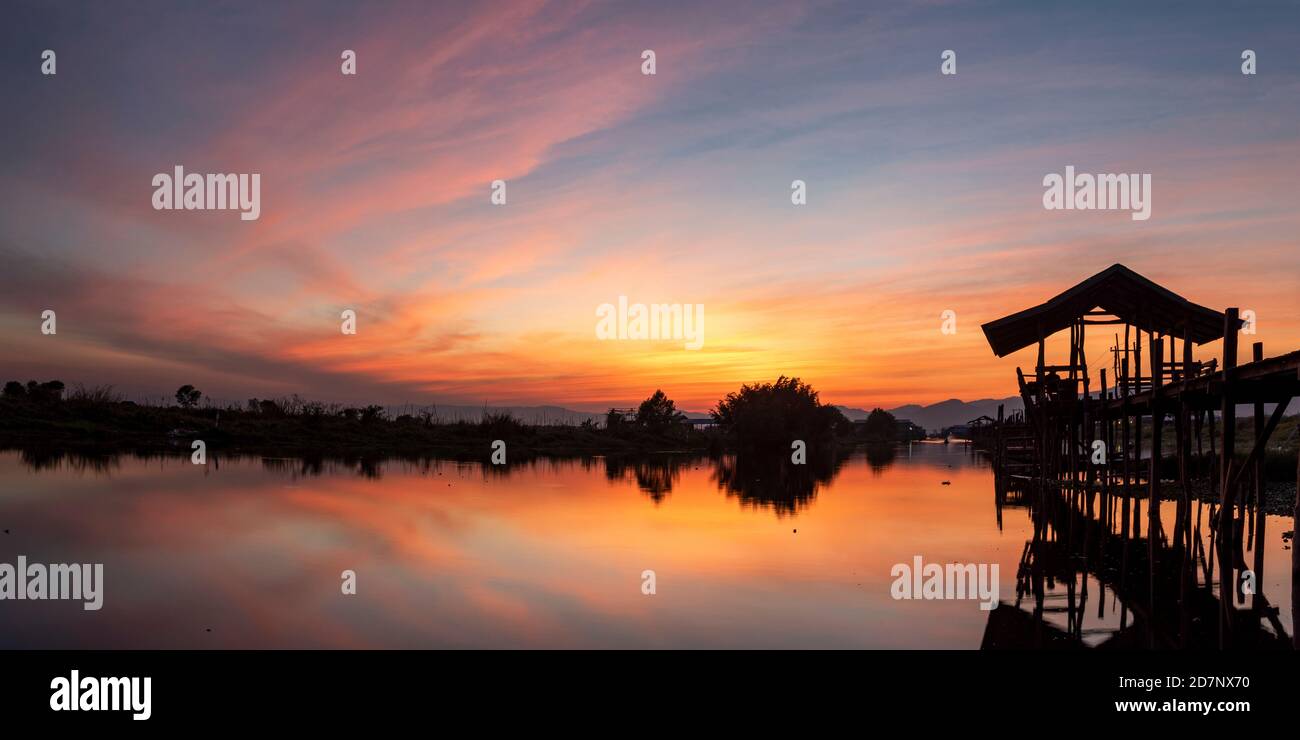 Sunset at the Maing Thouk Wooden Bridge, Inle Lake, Myanmar Stock Photo