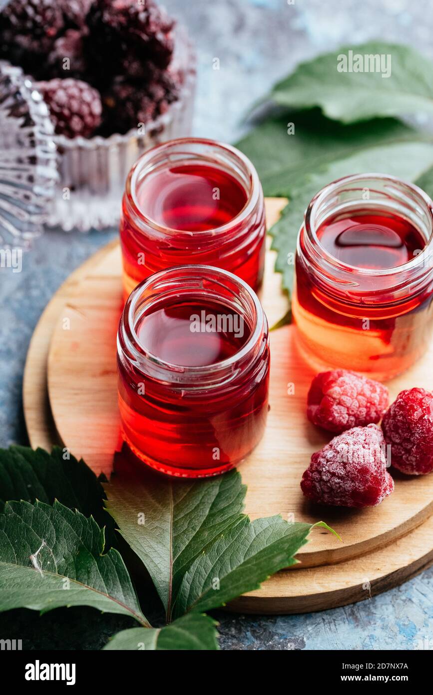 red alcoholic shots with various bartender's paraphernalia Stock Photo