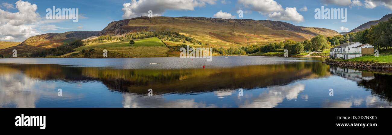 Panorama of Dovestone reservoir and hills with beautiful light, blue sky and clouds Stock Photo