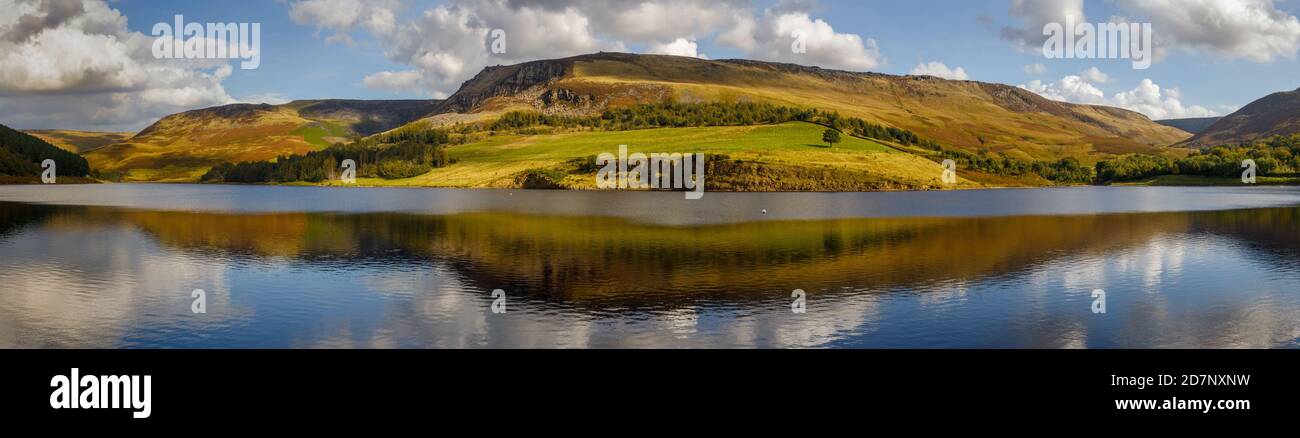 Panorama of Dovestone reservoir and hills with beautiful light, blue sky and clouds Stock Photo