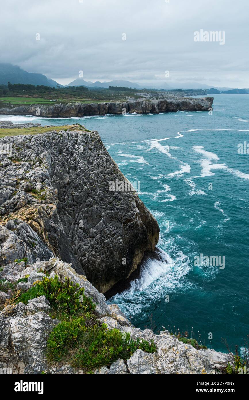 Scenic view of Cantabrian sea coast with tall cliffs and blue water at Bufones de Pria in Asturias, Spain. Stock Photo