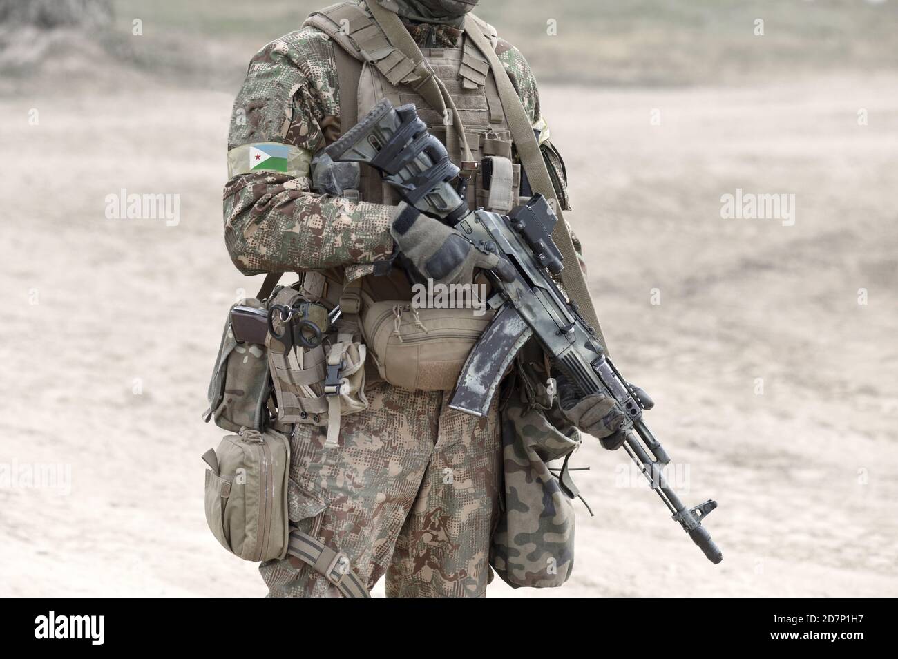 Soldier with assault rifle and flag of Djibouti on military uniform. Collage. Stock Photo