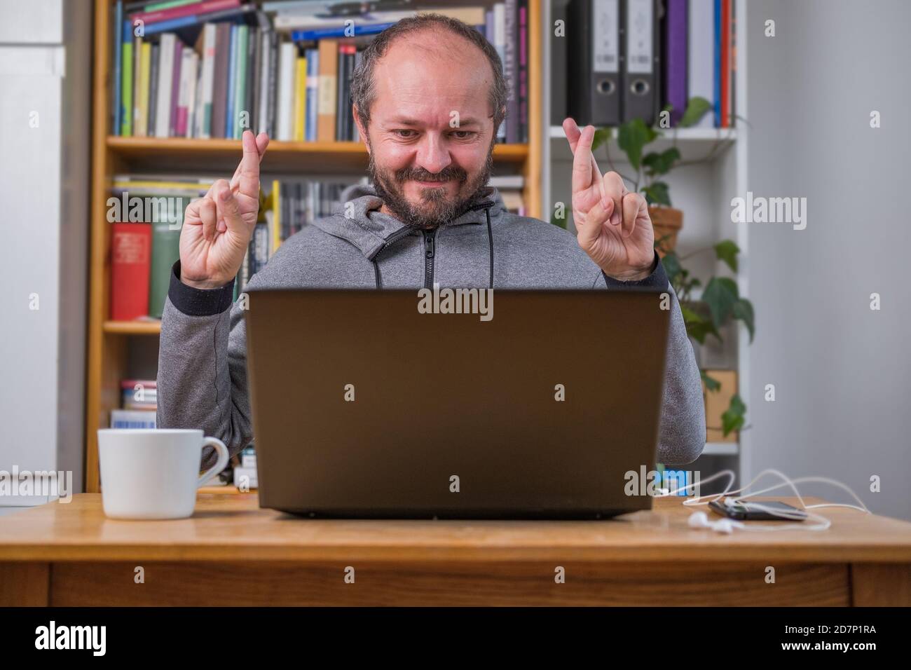 Man working online from home on computer laptop behind vintage desk